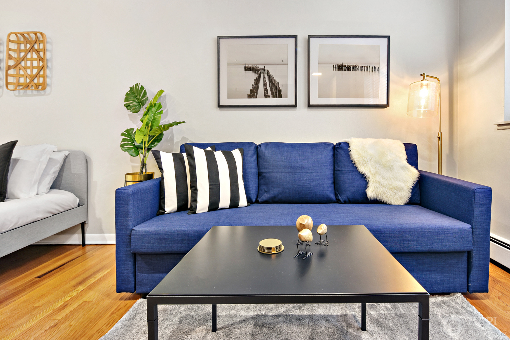 a living room with a blue couch and a coffee table