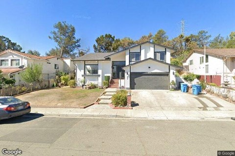 a house with a car parked in the driveway