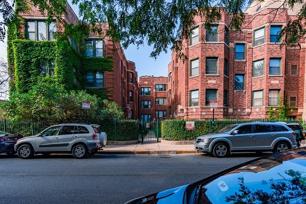 a city street with cars parked in front of buildings