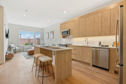 A kitchen with wooden cabinets and a large island.
