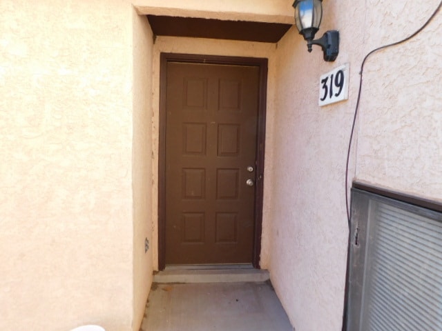 A brown door with a number 319 above it.