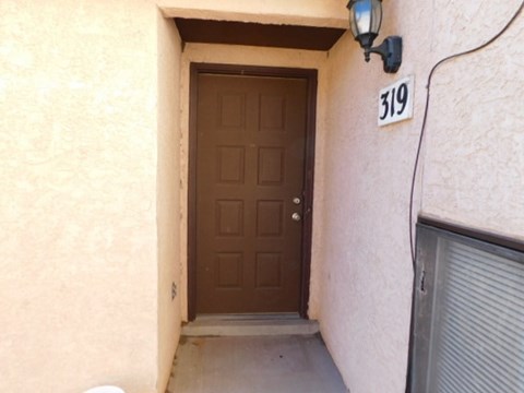 A brown door with a number 319 above it.