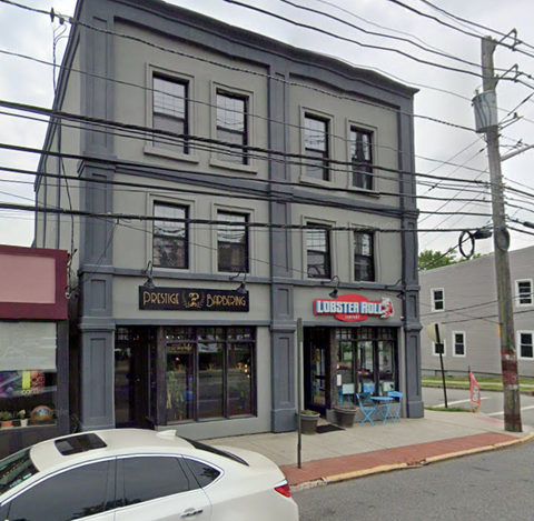 a white car parked in front of an old building