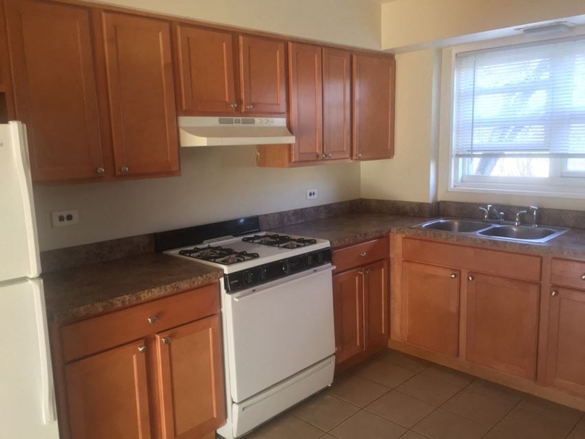 an empty kitchen with a stove and a sink