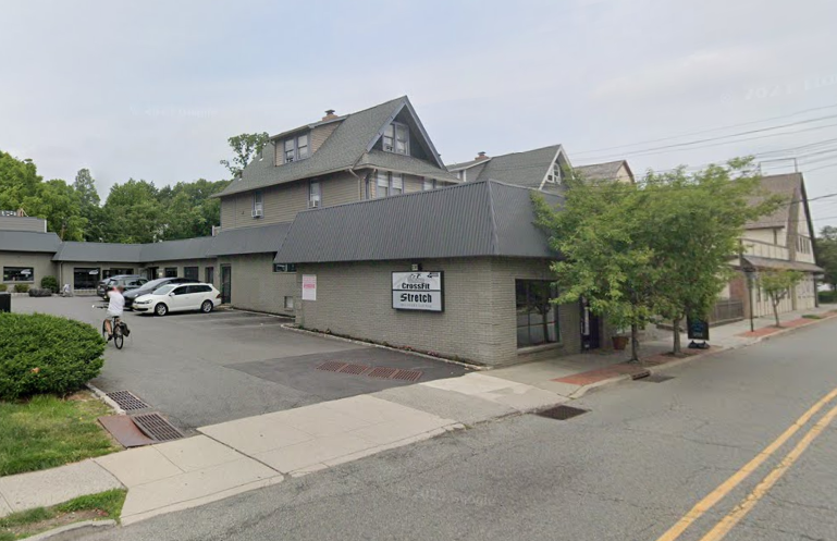 A street view of a building with a sign that reads "Zimmer Site".