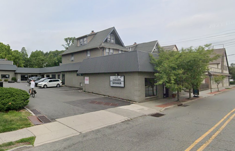 A street view of a building with a sign that reads "Zimmer Site".