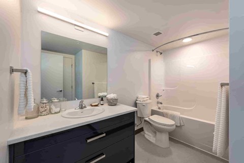 A bathroom with a sink, toilet, and bathtub.