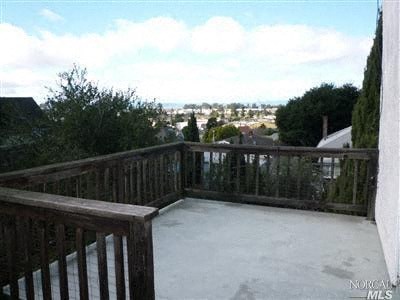 a balcony with a view of the city in the distance