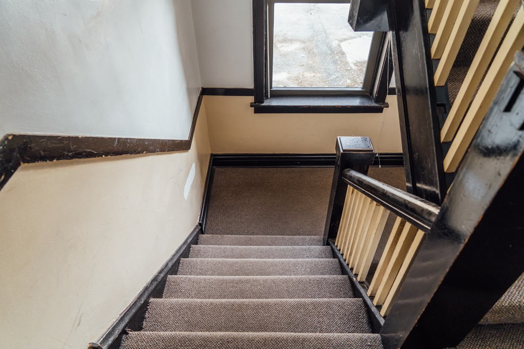 a set of stairs with a window at the top of them