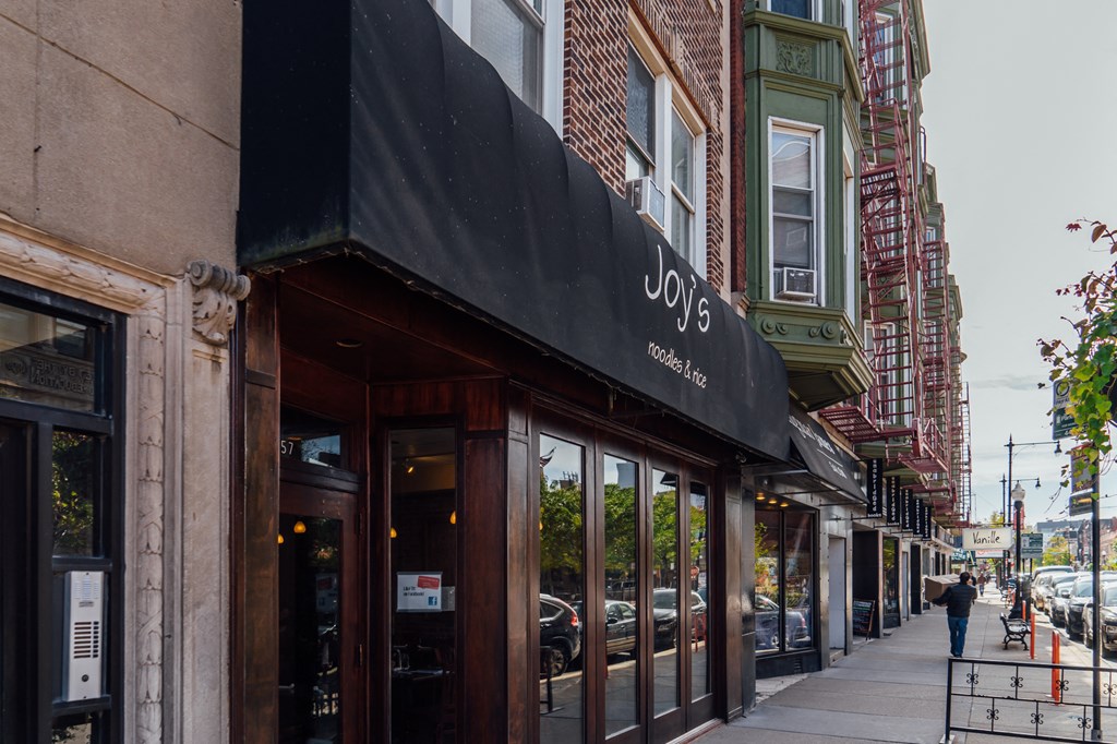 a black awning on a store front on a city street