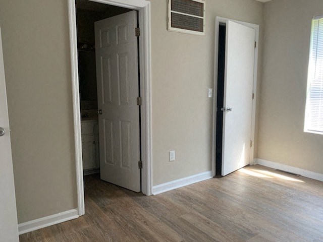 A room with a white door and a window.