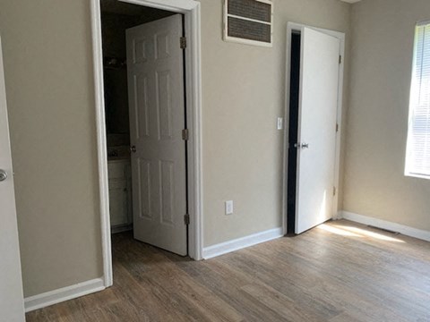 A room with a white door and a window.