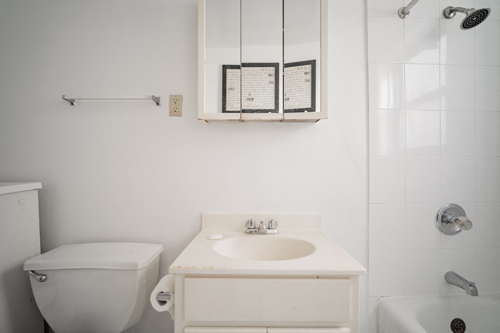 a white bathroom with a sink and a toilet