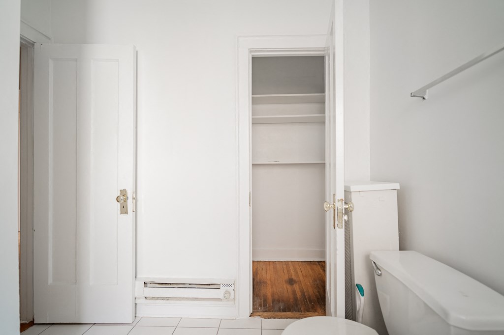 a small bathroom with a toilet and a closet