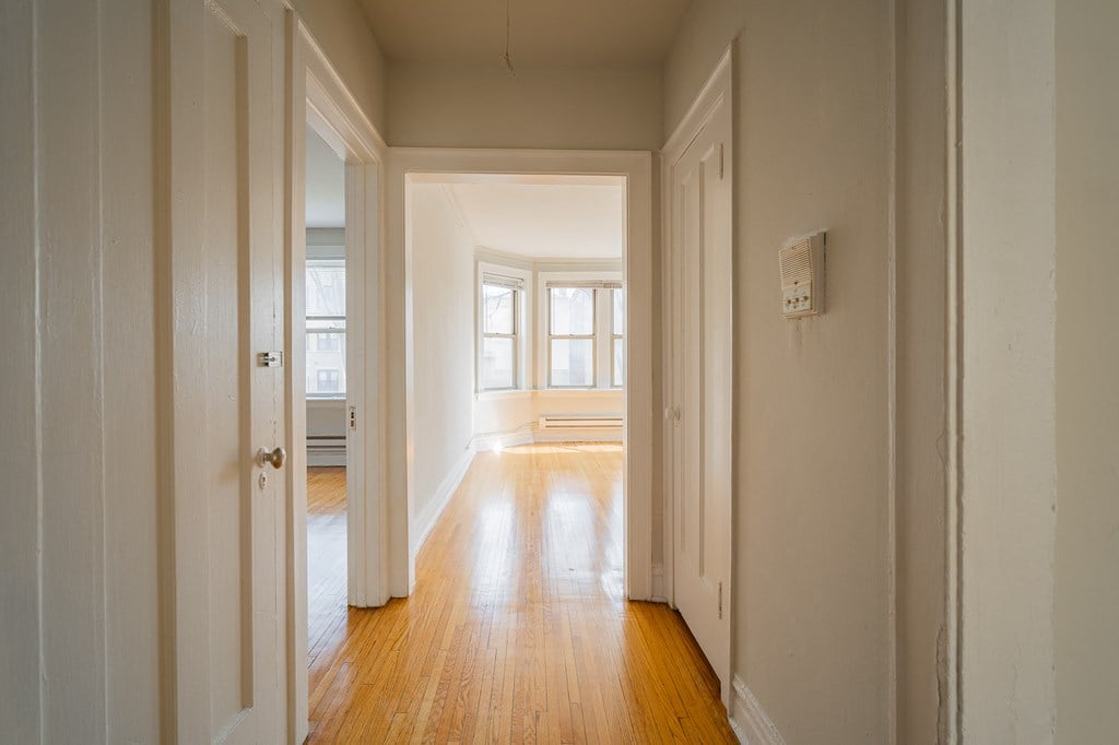 a empty room with wood floors and white walls