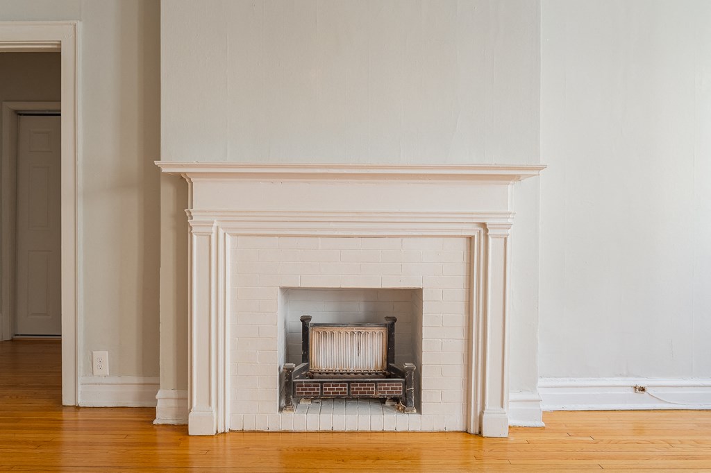 a fireplace in a living room with a wooden floor