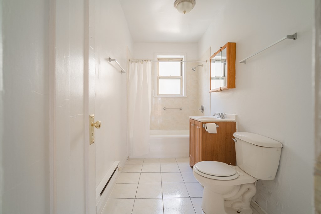 a bathroom with a toilet and a sink and a shower