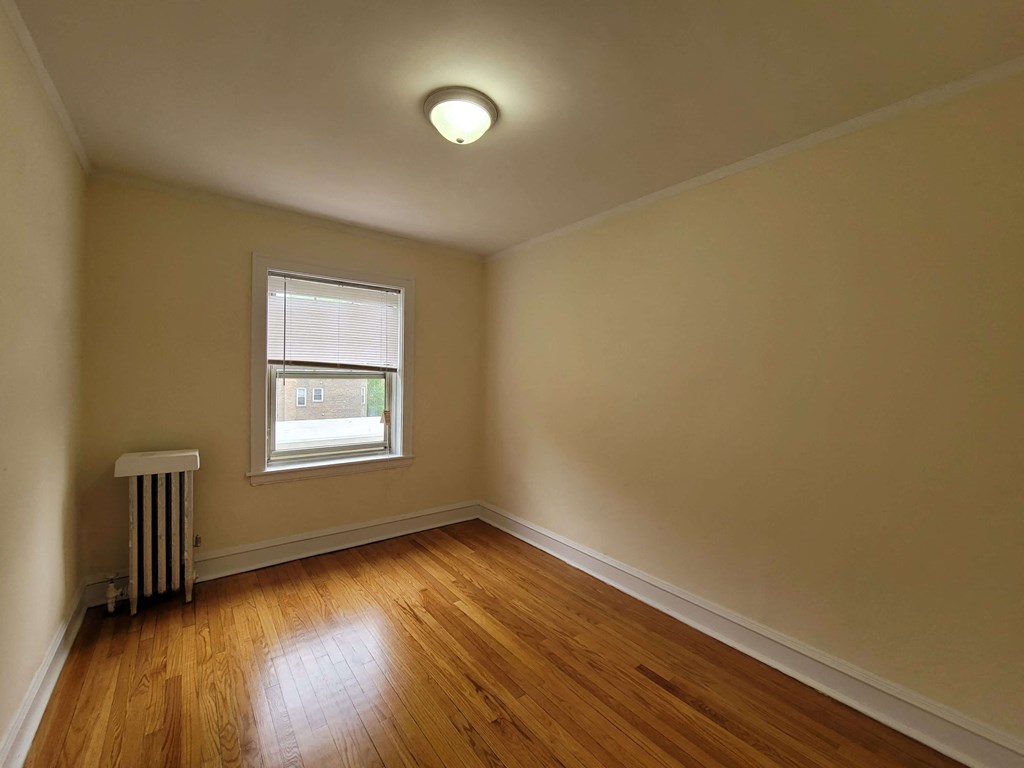 a living room with wood floors and a window