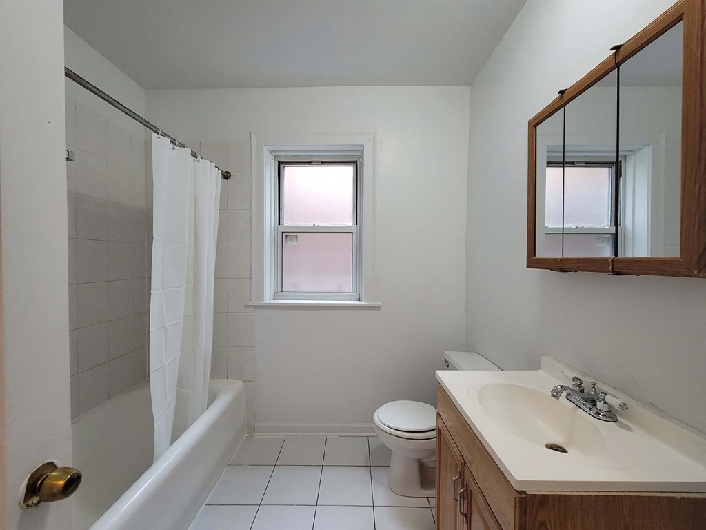 a bathroom with a sink toilet and a shower