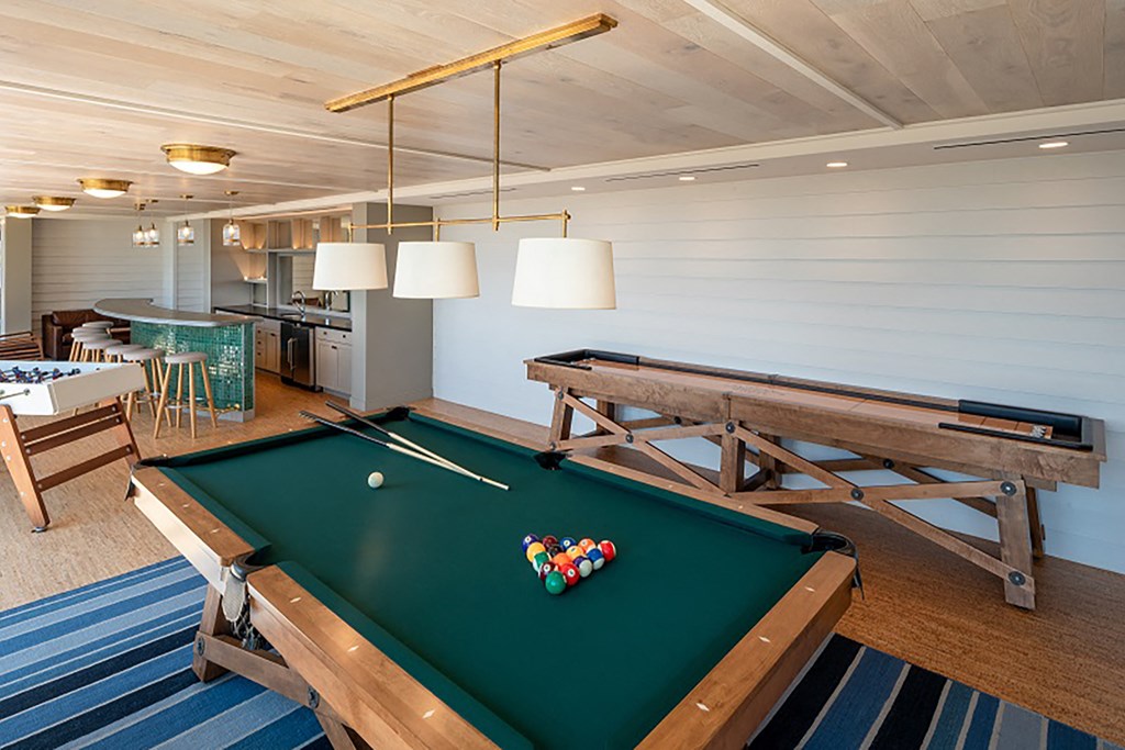 a billiards table in a game room with a pool