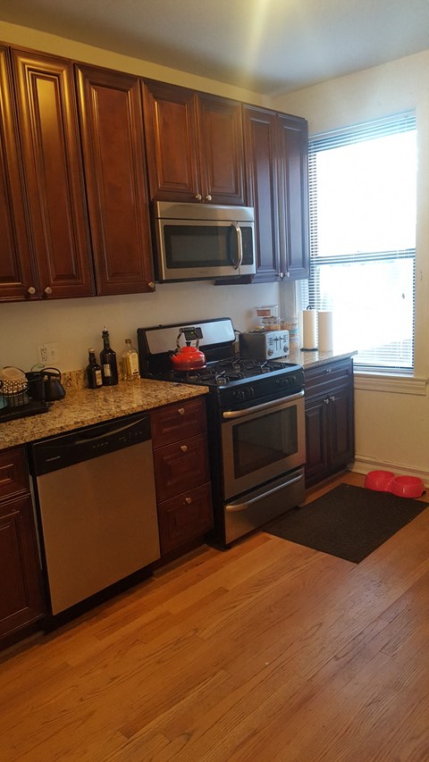a kitchen with wooden cabinets and stainless steel appliances