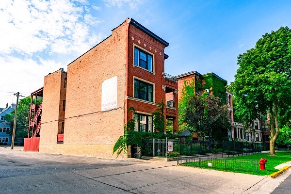 a red brick building on the side of a street