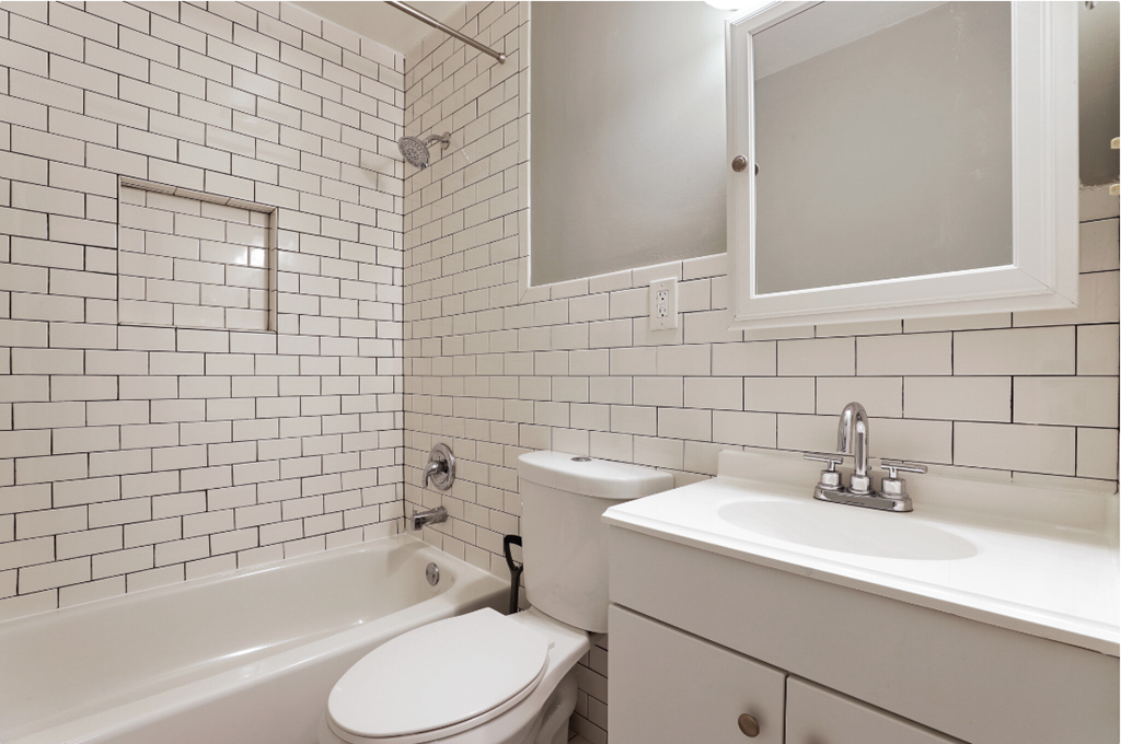 a white bathroom with a sink toilet and bath tub