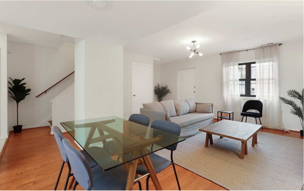 a living room with a glass table and a couch