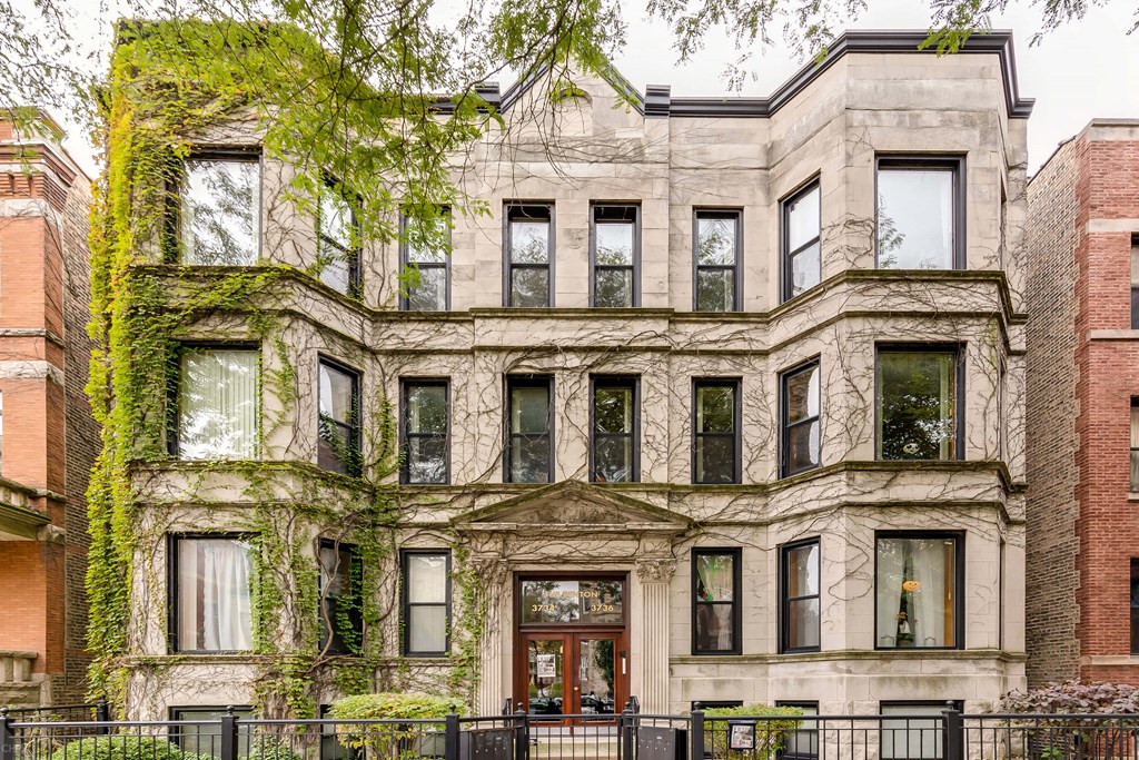 the exterior of a building with ivy growing on it