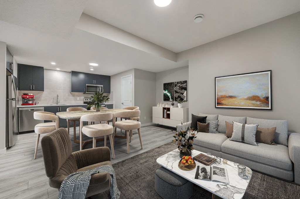 a living room and kitchen with a couch and a table