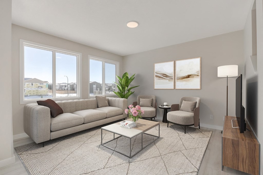 a living room with a couch and two chairs and a table