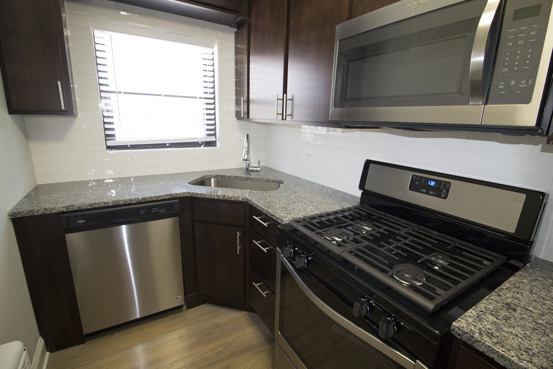 a kitchen with stainless steel appliances and granite counter tops
