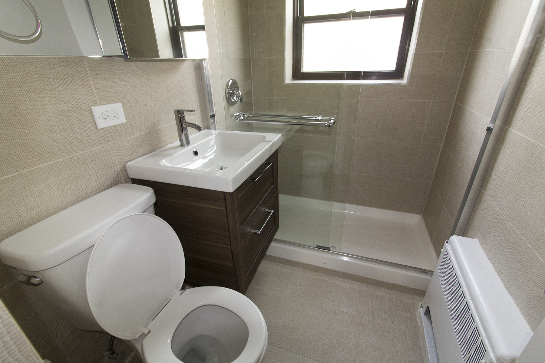 a bathroom with a toilet and a sink and a shower