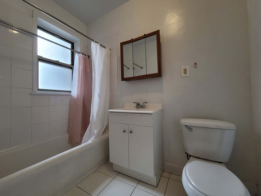 a bathroom with a toilet and a sink and a tub