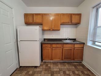 a small kitchen with a refrigerator and a sink