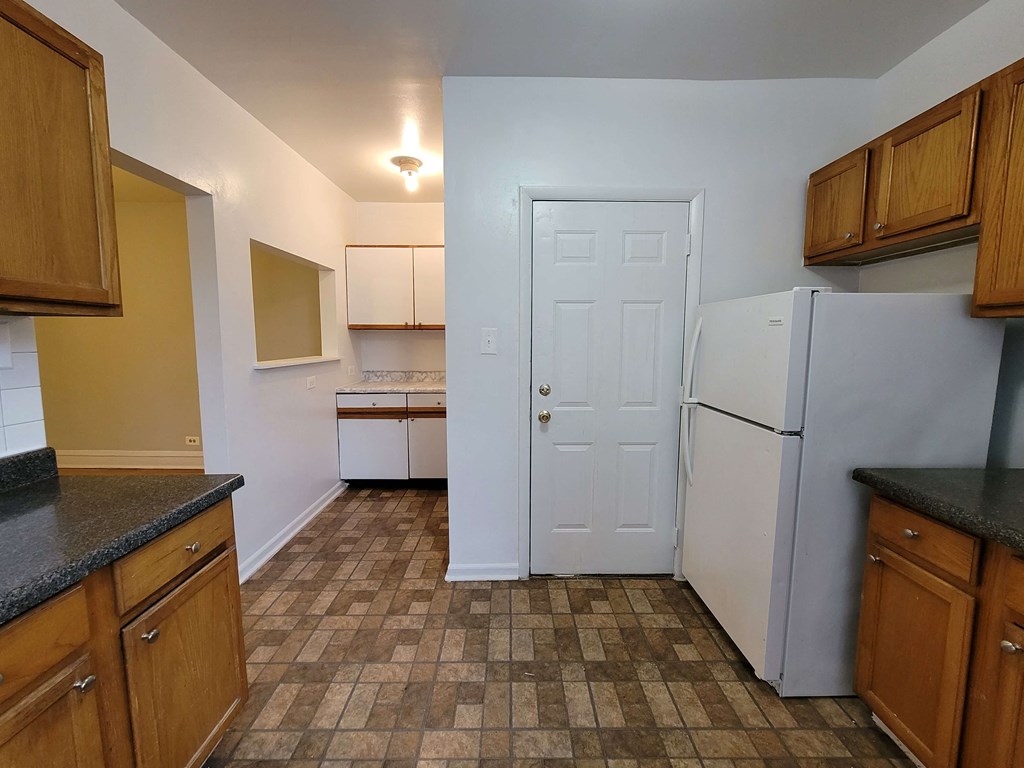a kitchen with a refrigerator and a door