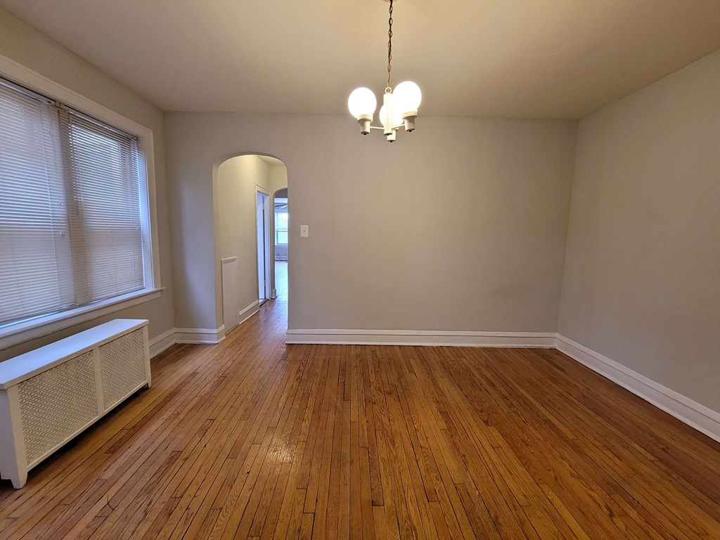 a living room with wood floors and a large window