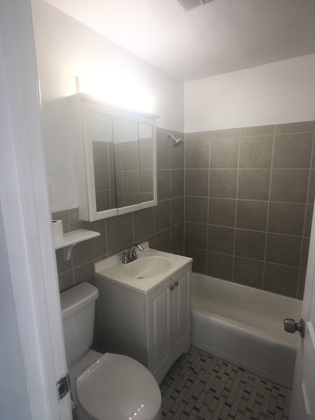 a small bathroom with a sink toilet and bath tub