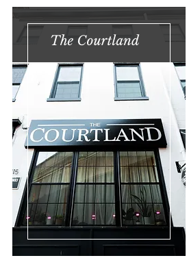 the front of the courtland hotel with a sign on the side of the building