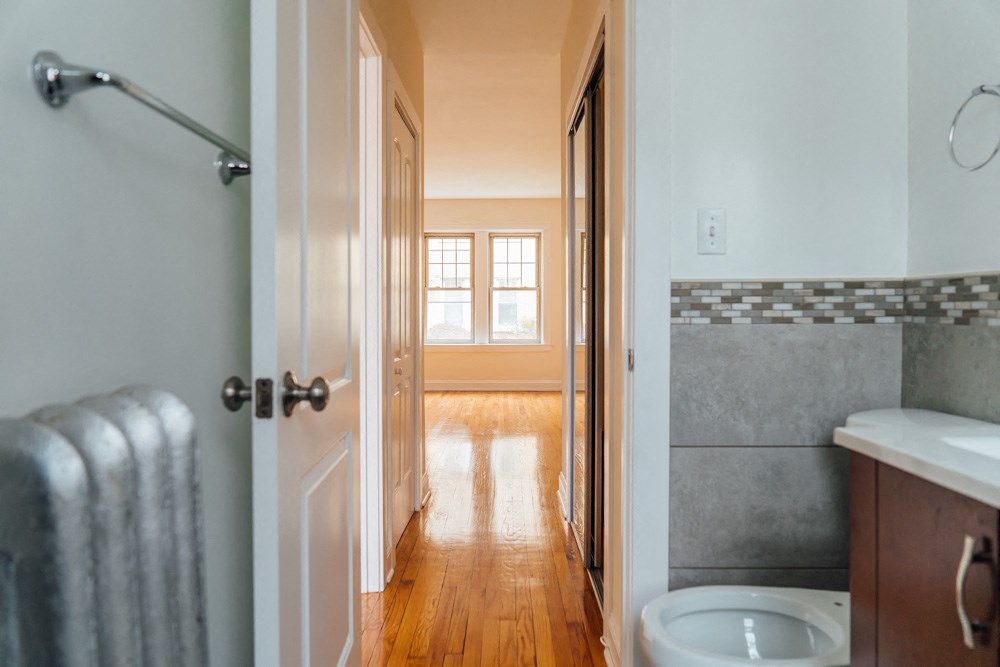 a bathroom with a toilet and a shower and a window