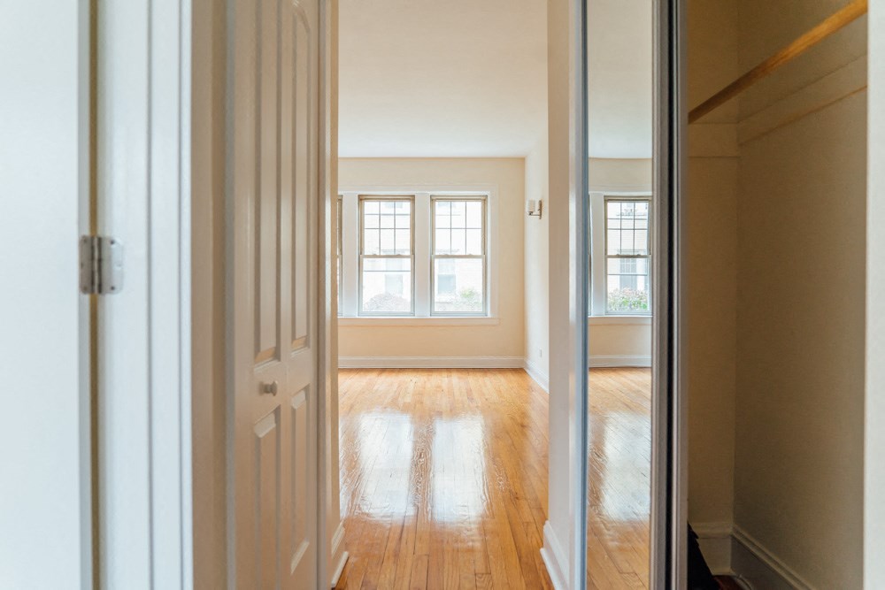 a empty room with a door open and a window