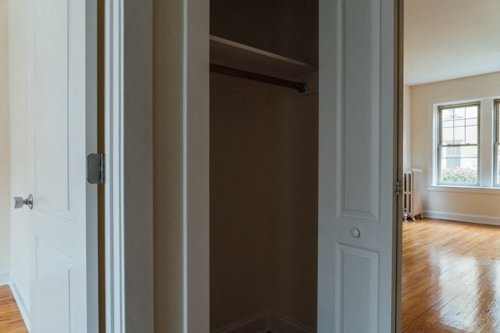 a room with a closet and a window and a door