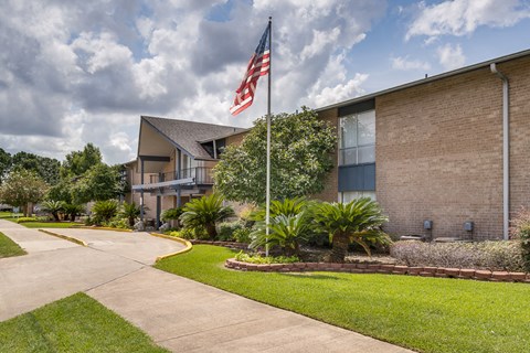 A building with a flag on a pole in front of it.