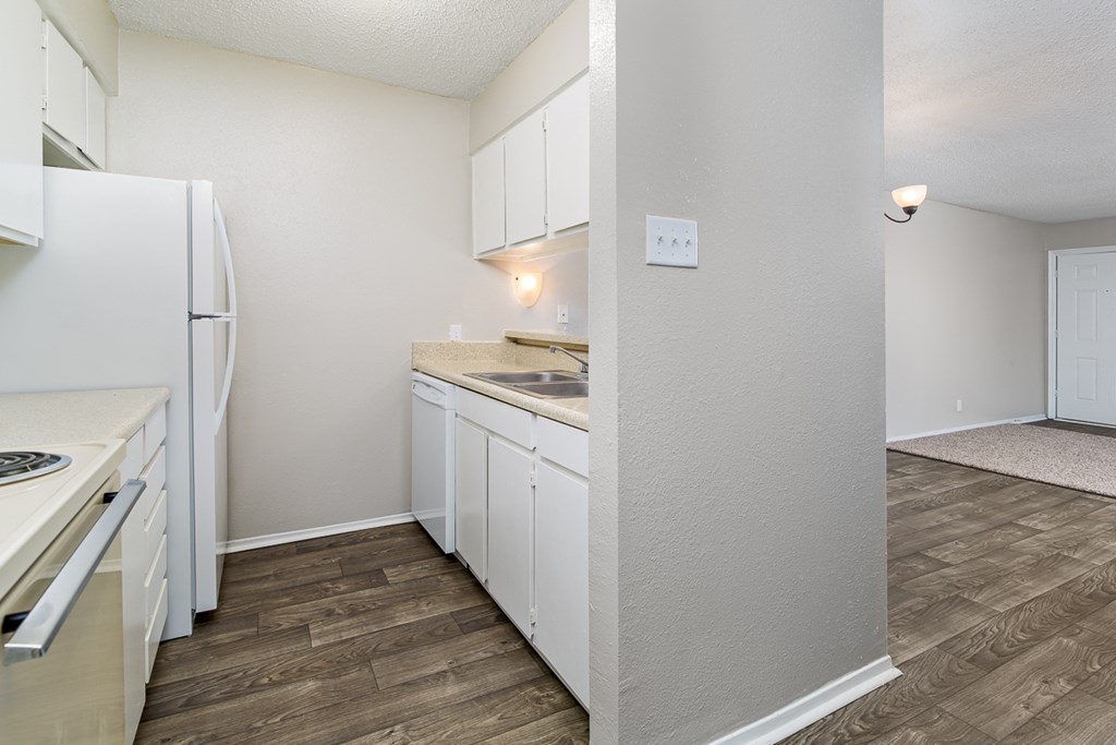 a kitchen with white cabinets and a white refrigerator