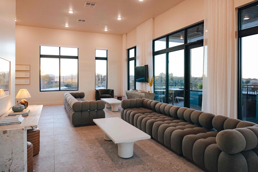 A living room with a long couch and a white coffee table.
