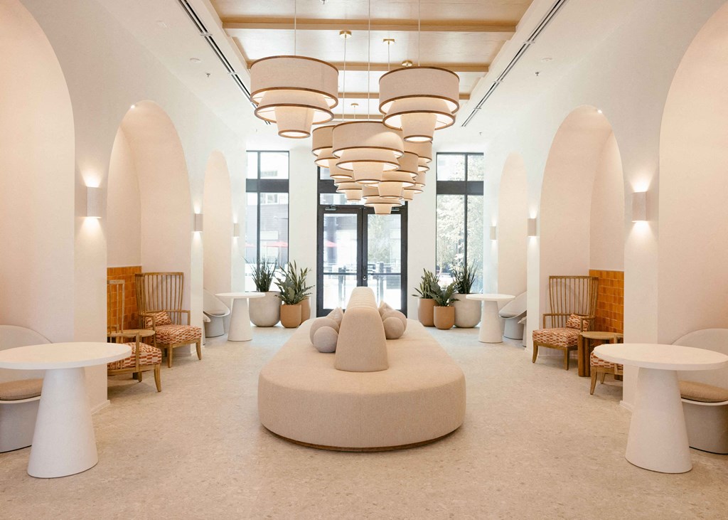 a large room with tables and chairs and a sculpture in the middle