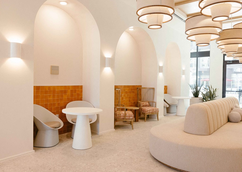 a large room with a couch and toilets and a table