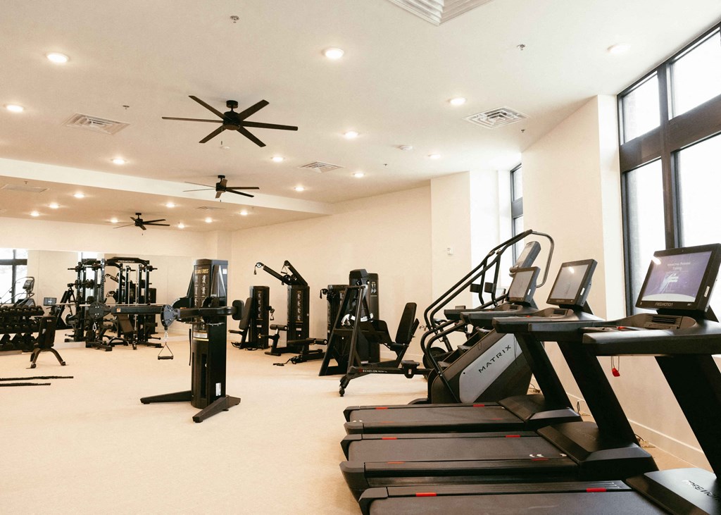 a gym with lots of treadmills and other exercise equipment