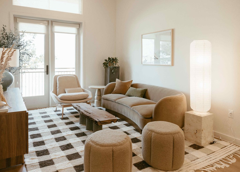 a living room with a couch and chairs and a checkered floor