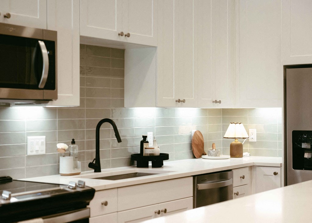 a kitchen with white cabinets and a sink